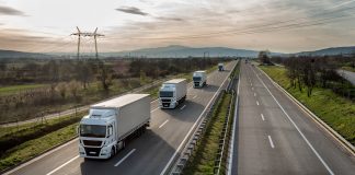 Caravan or convoy of trucks in line on a country highway