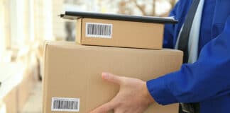 Courier with parcels on doorstep, closeup
