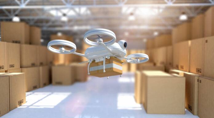 Remote controlled drone taking off from warehouse to deliver package